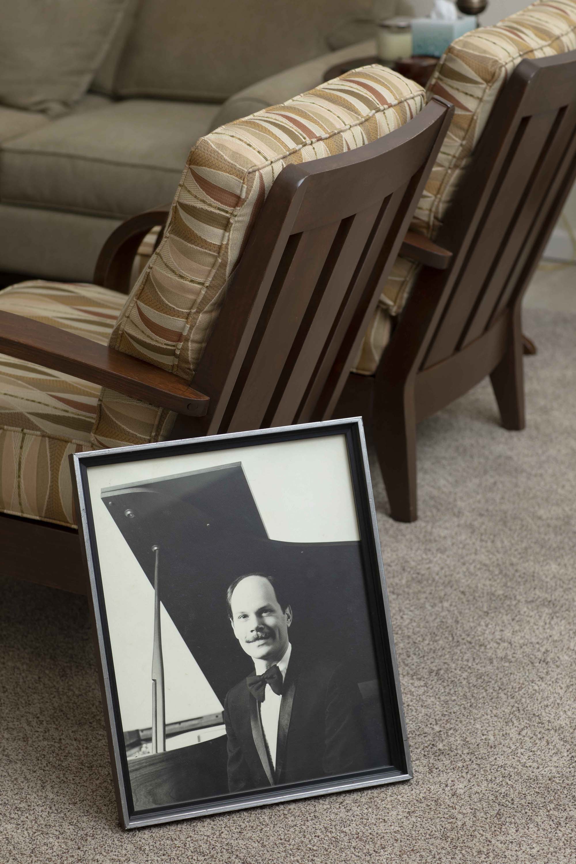 A photo depicting a young Cliff Shockney at the piano leans against a living room chair.