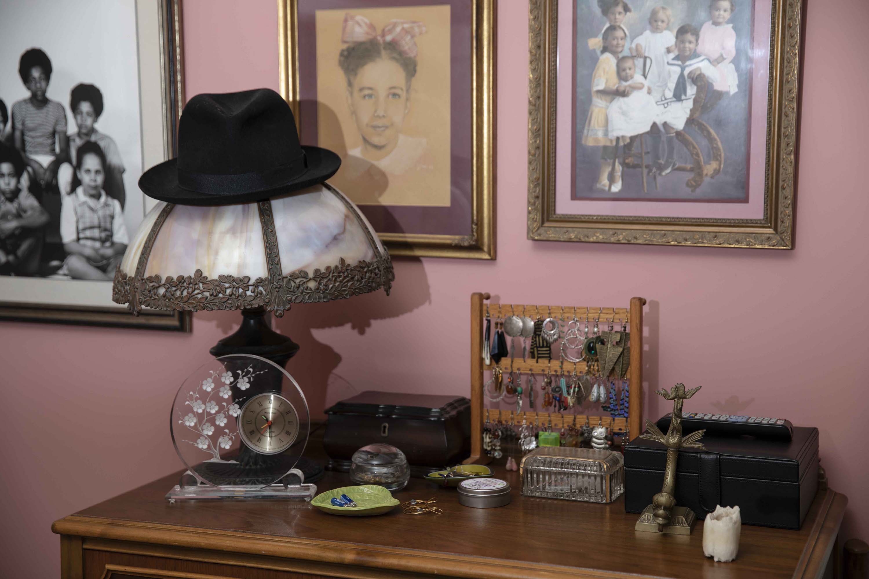 Family photos and vintage mementos adorn Regina Jones' bedroom in her central Los Angeles home. Jones wanted to downsize, but could not find an affordable home in a community “with good walking-distance shopping and a little place to grab a bite to eat,” she said.